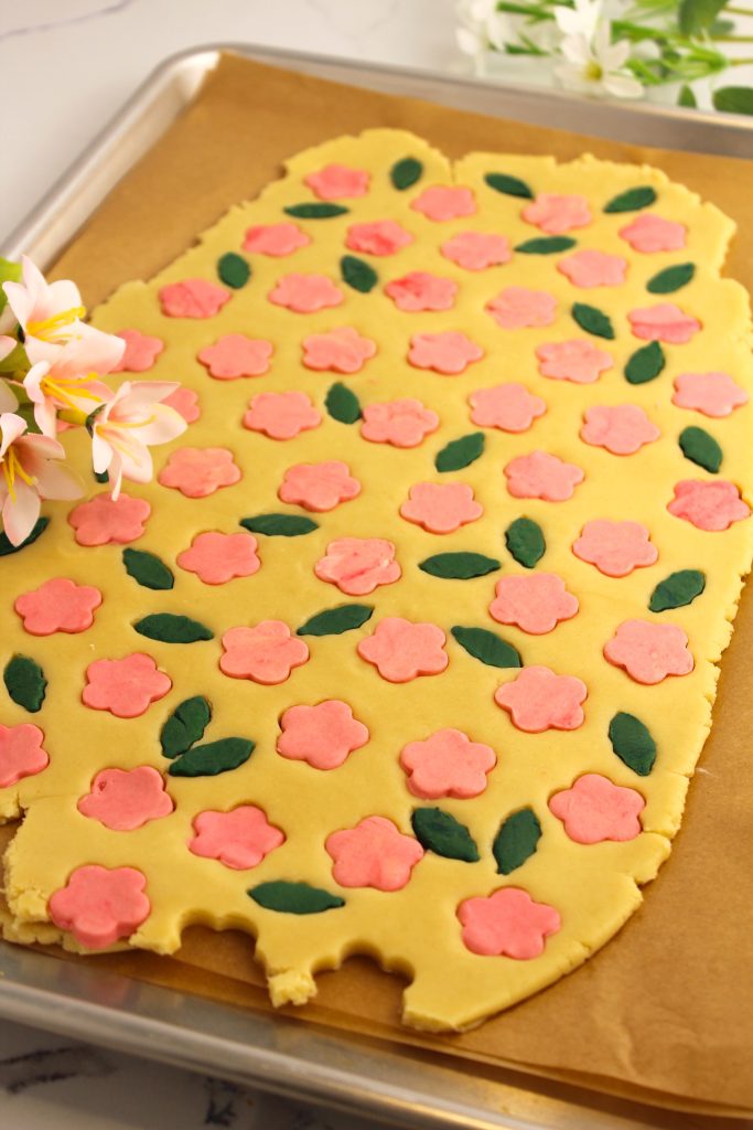 rolled out dough filled in with pink flowers and green leaves