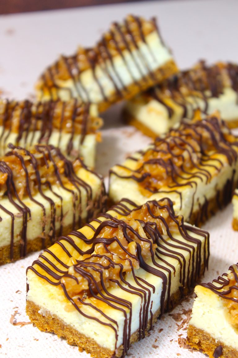 Decadent cheesecake bars drizzled with rich chocolate and caramel sauce, teasing the taste buds with their swirls of sweetness.